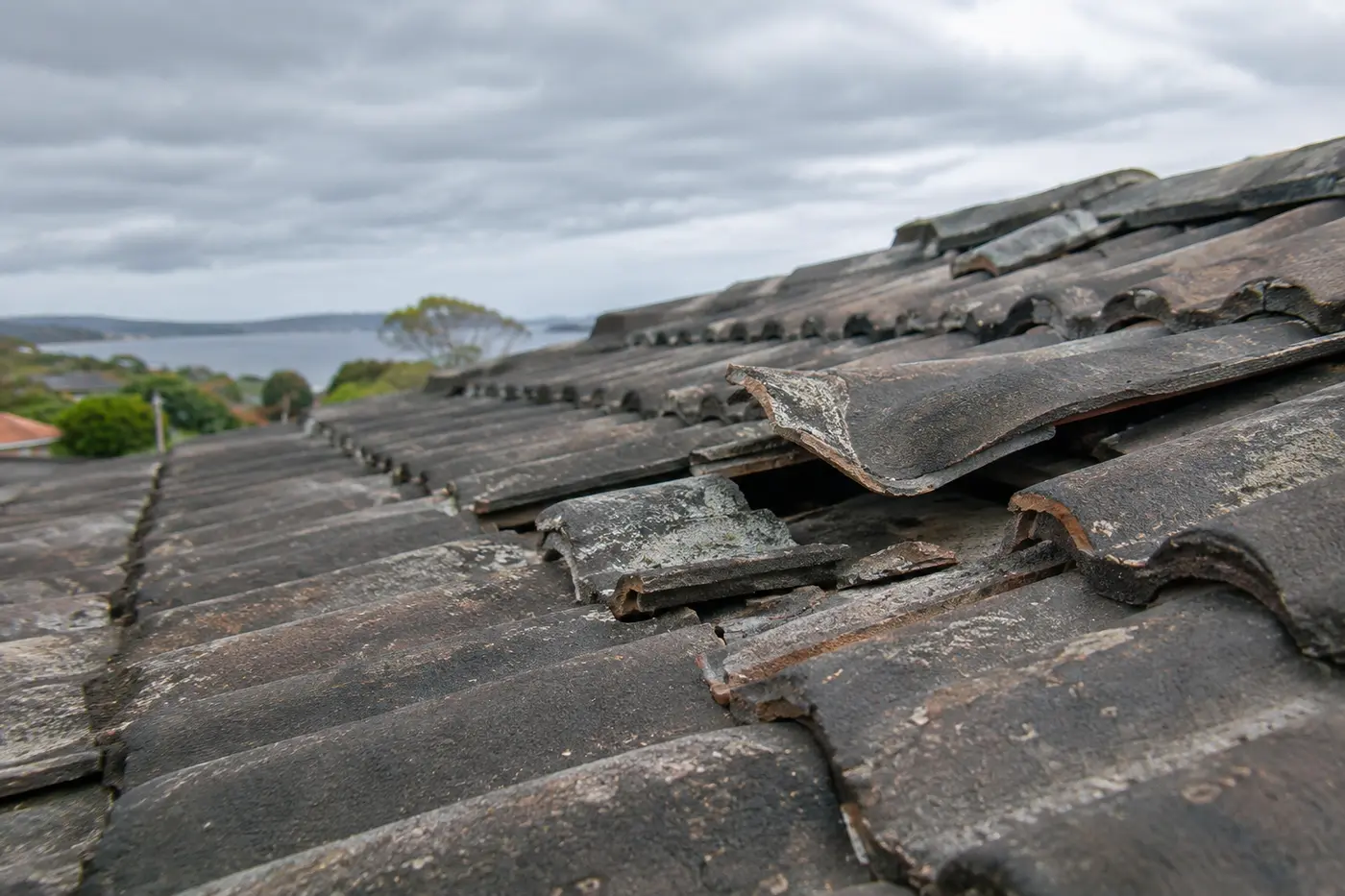 Storm-damaged tiled roof on a Central Coast home with cracked and slipped tiles