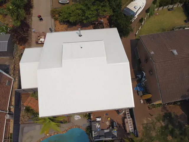 Aerial view of a new Colorbond Surfmist metal roof on a Terrigal home with a pool