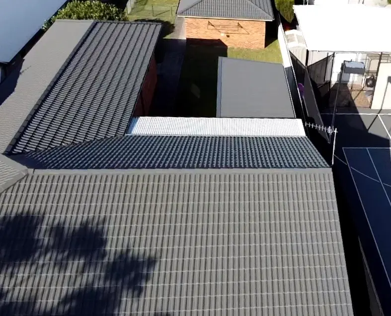 Restored Woodland Grey tile roof in Terrigal seen from above, with a tennis court beside it