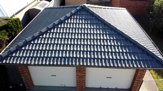 Close view of a restored concrete tile roof in Woodland Grey over a double garage in Terrigal