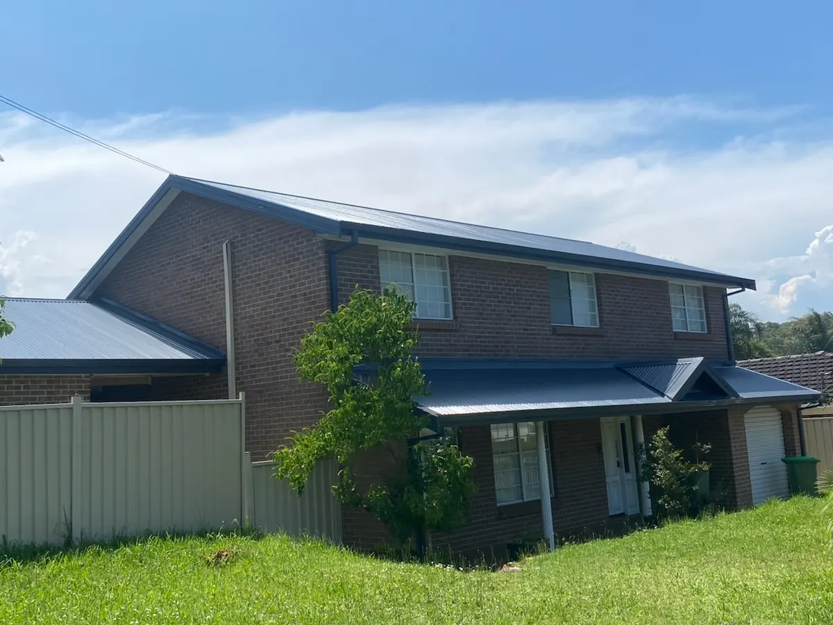 Full metal roof on a two-storey brick home — Central Coast